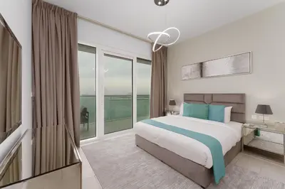 a bedroom with a bed and a large window at Maison Privee - Seaside JBR Living w/ Open Sea & Bluewaters Views in Dubai