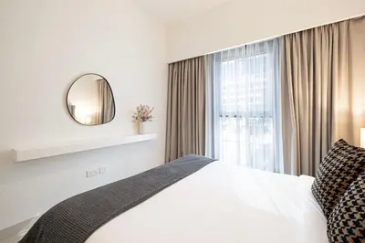 a bedroom with a bed with a mirror and a window at Burj Crown - First Class Boulevard View, 9 min Walk Dubai Mall in Dubai