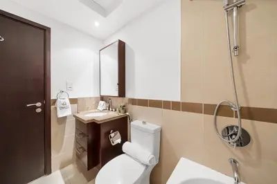 a bathroom with a toilet and a sink and a mirror at Luxury Studio, 29 Boulevard near Burj Khalifa Downtown - Chalet Homes in Dubai