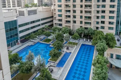 an aerial view of a building with two pools at Luxury Studio, 29 Boulevard near Burj Khalifa Downtown - Chalet Homes in Dubai