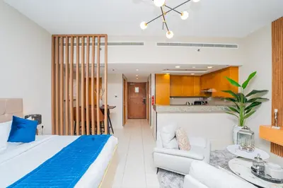 a bedroom with a king sized bed and a living room at Escape24 Spacious Studio with Balcony near Dubai Mall in Dubai