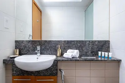 a bathroom with a sink and a mirror at Escape24 Spacious Studio with Balcony near Dubai Mall in Dubai