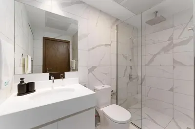 a bathroom with a toilet and a sink and a shower at Luxury Living resort style in Zaya Hameni in Dubai