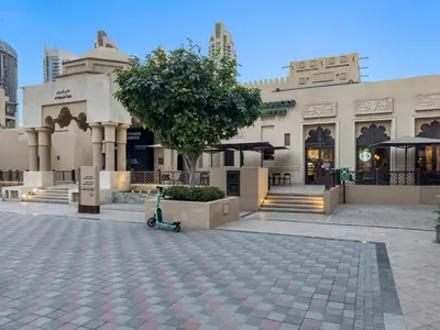 a building with a tree in the middle of a courtyard at Stylish 1BR in Old Dubai Balcony, Smart TV, Full Kitchen in Dubai