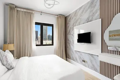 a bedroom with a white bed and a tv at Stylish 1BR in Old Dubai Balcony, Smart TV, Full Kitchen in Dubai