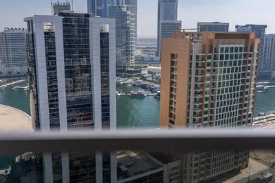 a view of a city with tall buildings and a river at MAG318, Modern Studio Apartment with Great Amenities and Canal View, 5min Walk to Dubai Mall in Dubai