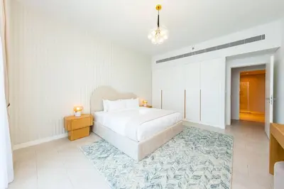 a white bedroom with a bed and a rug at Fantastic and Rare 4BR+maid's in JBR Walk in Dubai