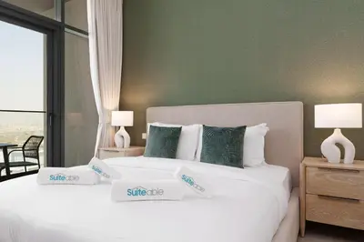 a bedroom with two white beds with green walls at Your Exclusive Retreat in Dubai Hills by Suiteable in Dubai