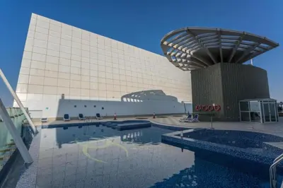 a large building with a swimming pool in front of it at Click Stay - JLT - Studio & Balcony Lakes view Entire Apartment -RA in Dubai