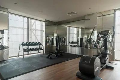 a gym with treadmills and exercise equipment in a building at StoneTree - Spacious Studio - The Matrix in Dubai