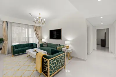 a living room with green couches and a table at 2BR apartment in downtown Dubai, near Burj Khalifa in Dubai
