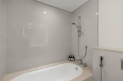 a bath tub in a bathroom with a shower at 2BR apartment in downtown Dubai, near Burj Khalifa in Dubai