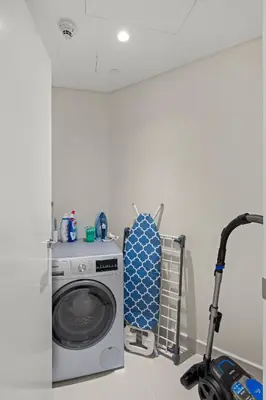 a washing machine in a kitchen with a vacuum at 2BR apartment in downtown Dubai, near Burj Khalifa in Dubai