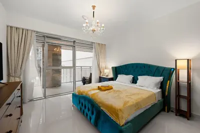 a bedroom with a blue bed and a chandelier at 2BR apartment in downtown Dubai, near Burj Khalifa in Dubai
