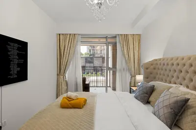 a bedroom with a bed with a yellow towel on it at 2BR apartment in downtown Dubai, near Burj Khalifa in Dubai