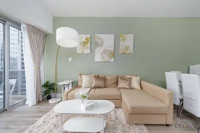 a living room with a couch and a table at Comfortable 1BR Apartment in Marina Tower, Dubai Marina by Deluxe Holiday Homes in Dubai