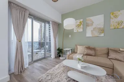 a living room with a couch and a table at Comfortable 1BR Apartment in Marina Tower, Dubai Marina by Deluxe Holiday Homes in Dubai