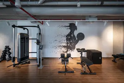 a gym with a wall with a picture of a woman at TH-Homes designed apartment Downtownview in Dubai
