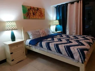 a bedroom with a bed and a night stand with a lamp at Click Stay - JLT - Entire Studio & Balcony Lakes view Apartment -AM in Dubai