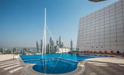 a swimming pool on the roof of a building with a city at Click Stay - JLT - Entire Studio & Balcony Lakes view Apartment -AM in Dubai