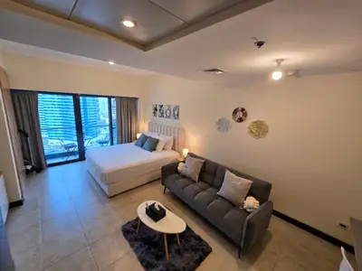 a living room with a couch and a bed at Click Stay - JLT - Entire Studio & Balcony Lakes view Apartment -NA in Dubai