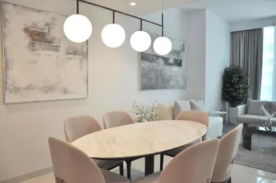 a dining room with a table and chairs at Sea Breeze Oasis in Dubai