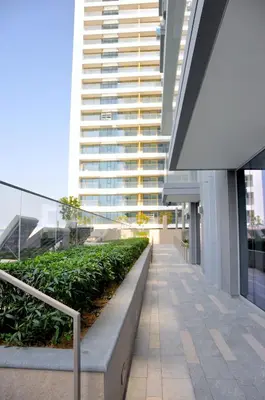 a walkway in a building with a tall building at Sea Breeze Oasis in Dubai