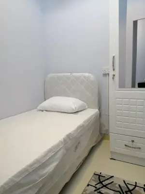 a bedroom with a white bed and a mirror at MOE Hostel By PHM in Dubai