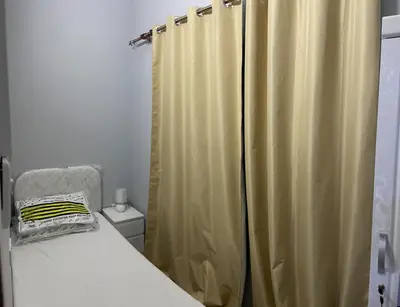 a bedroom with a bed and a shower curtain at MOE Hostel By PHM in Dubai