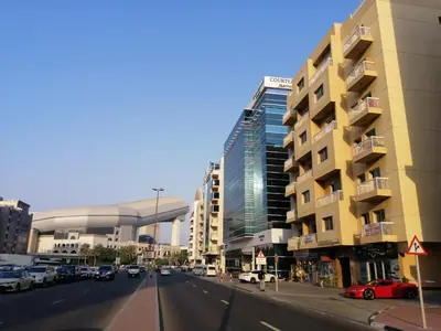 a city street with cars parked in front of buildings at MOE Hostel By PHM in Dubai