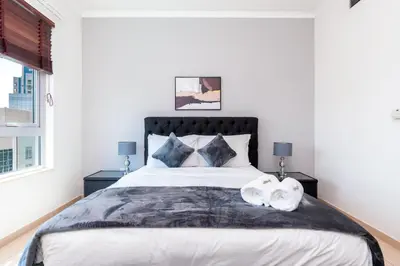 a bedroom with a large bed with two pillows at Incredible Fountain Views 2.5 BR Burj Residences in Dubai