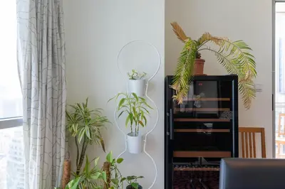 a white shelf with plants in a living room at Incredible Fountain Views 2.5 BR Burj Residences in Dubai