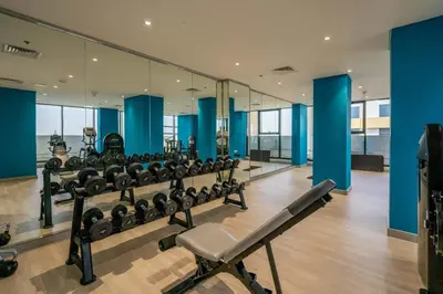 a gym with a row of treadmills and machines at GuestReady - Urban Retreat in Downtown in Dubai