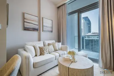a living room with a white couch and a large window at Exclusive Rate 1BR with Partial Burj Khalifa Views by Deluxe Holiday Homes in Dubai