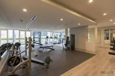 a gym with treadmills and cardio equipment in a building at Exclusive Rate 1BR with Partial Burj Khalifa Views by Deluxe Holiday Homes in Dubai