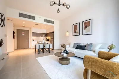 a living room with a couch and a table at Beautiful 1BR in Creek Edge Tower 2, Dubai Creek Harbor by Deluxe Holiday Homes in Dubai