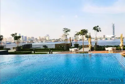 a large swimming pool with a view of the city at Beautiful 1BR in Creek Edge Tower 2, Dubai Creek Harbor by Deluxe Holiday Homes in Dubai