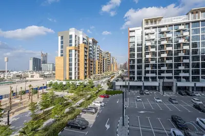 an aerial view of a parking lot with tall buildings at Comfy 1BR in Azizi Riviera 8, Al Merkadh by Deluxe Holiday Homes in Dubai
