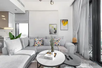 a living room with a couch and a table at Comfy 1BR in Azizi Riviera 8, Al Merkadh by Deluxe Holiday Homes in Dubai