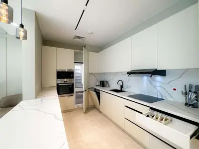 a kitchen with white cabinets and a sink at Exquisite 1BR Hidden Gem - Oceana Residences in Dubai