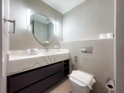 a bathroom with a sink and a toilet and a mirror at Exquisite 1BR Hidden Gem - Oceana Residences in Dubai