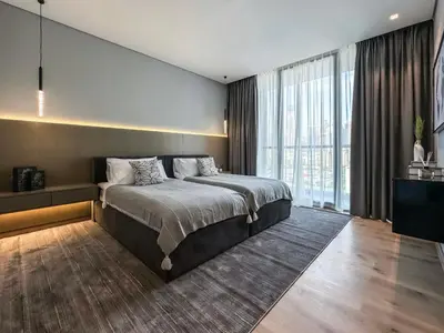 a bedroom with a large bed and a large window at Majestic 2BR Haven with Burj Khalifa View in Dubai
