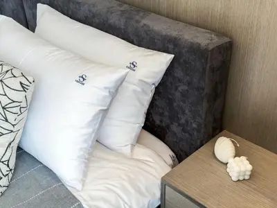 two white pillows sitting on top of a bed at Majestic 2BR Haven with Burj Khalifa View in Dubai