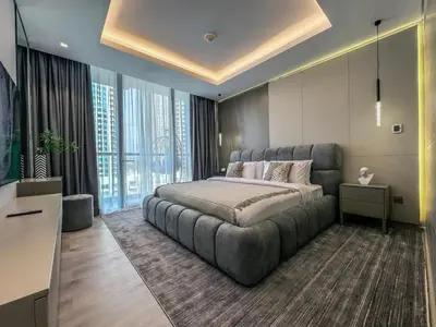 a bedroom with a large bed and a large window at Majestic 2BR Haven with Burj Khalifa View in Dubai