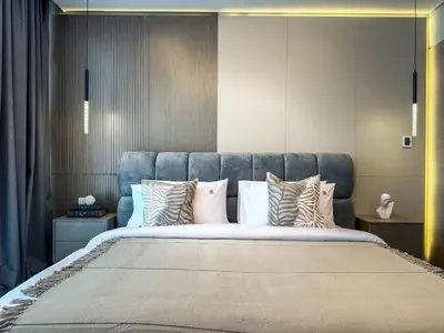 a bedroom with a large bed with many pillows at Majestic 2BR Haven with Burj Khalifa View in Dubai