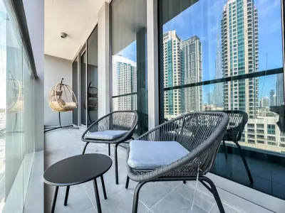 a balcony with two chairs and a view of the city at Majestic 2BR Haven with Burj Khalifa View in Dubai