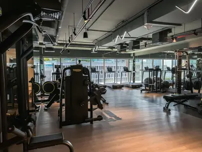 a gym with lots of treadmills and machines at Majestic 2BR Haven with Burj Khalifa View in Dubai
