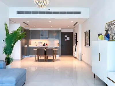 a kitchen and living room with a dining room at Vibrant 1BR Apartment with Marina & Ocean View in Dubai