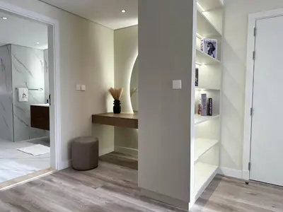 a bathroom with a walk in shower and a mirror at Charming Ocean View 1BR Apartment at 5 Star Resort in Dubai