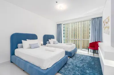 a hotel room with two beds and a window at High class apartment in Dubai